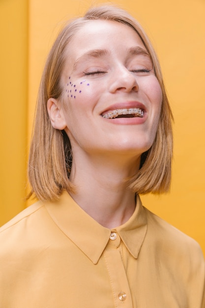 Free Photo portrait of blonde woman in a yellow scene