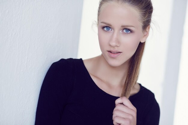 Portrait of blue eye's woman in a black dress.