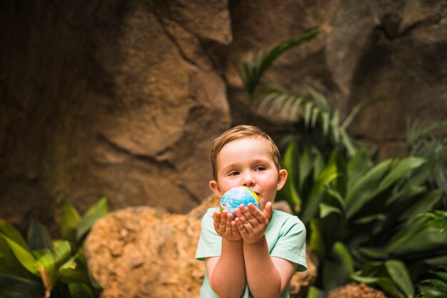 Portrait of a boy holding globe in hand