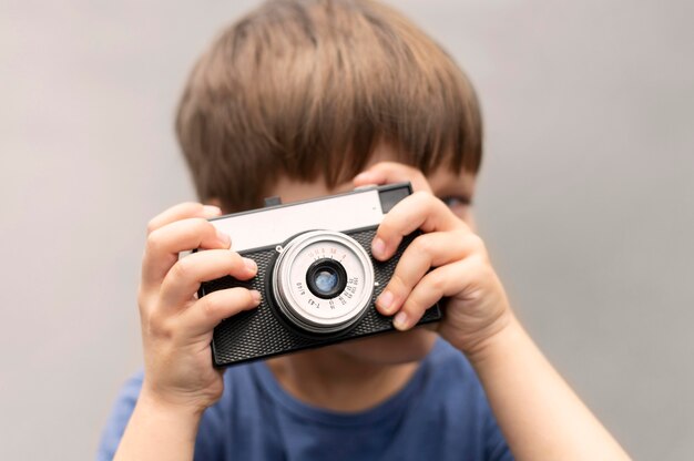 Portrait boy with camera