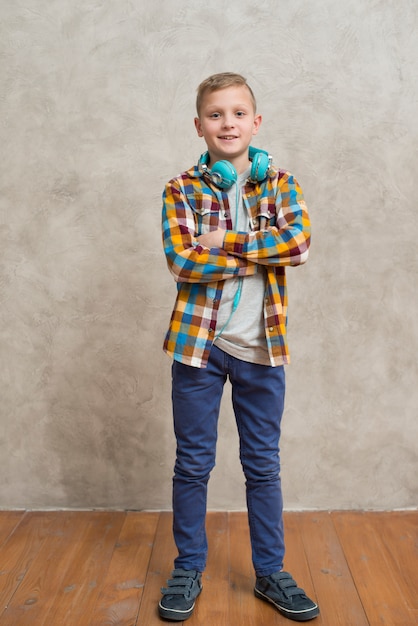 Free Photo portrait of boy with headphones around neck