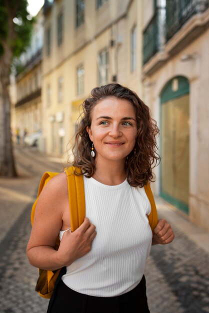 Portrait of braless woman outdoors with backpack