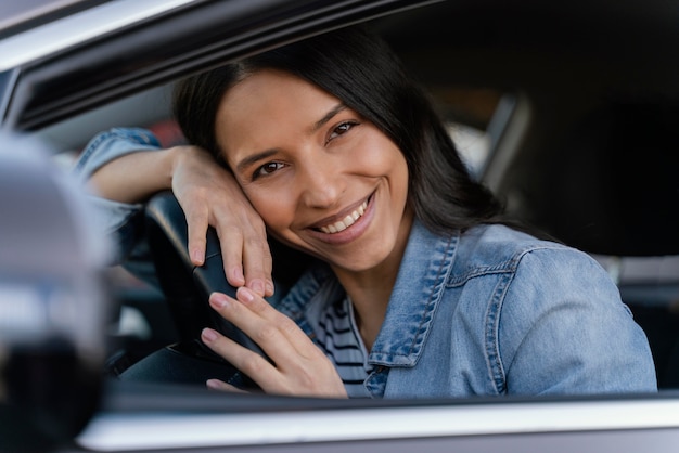 Portrait of brunette woman in her car