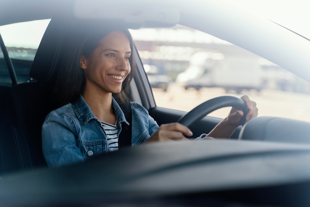 Portrait of brunette woman in her car