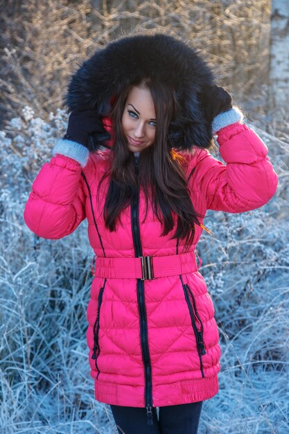 Free photo portrait of brunette woman in pink winter coat.