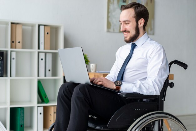 Portrait of business man working on a laptop