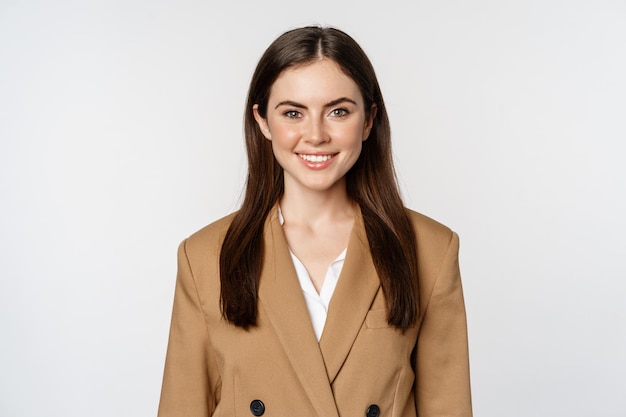 Portrait of business woman with enthusiastic face expression smiling looking confident standing in s...