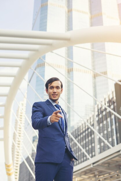 Portrait of Businessman standing against the building outdoors.