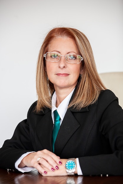 Portrait of businesswoman in her 40s at the office smiling at the camera. Joyfull woman.