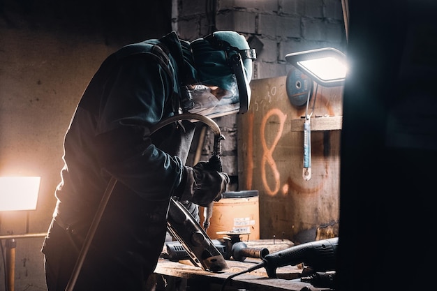 Free photo portrait of busy working man at his workplace at the metal factory.