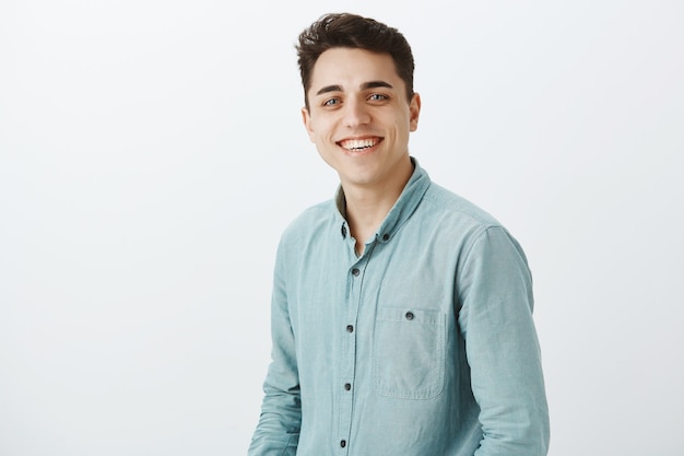 Portrait of carefree happy european guy in casual shirt