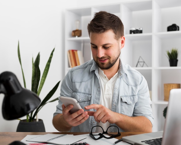 Portrait of casual male browsing mobile phone