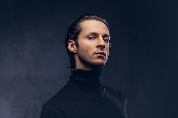 Free photo portrait of a charismatic sensual male in black sweater with wet