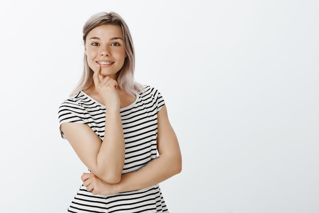 Portrait of charming blonde girl posing in the studio