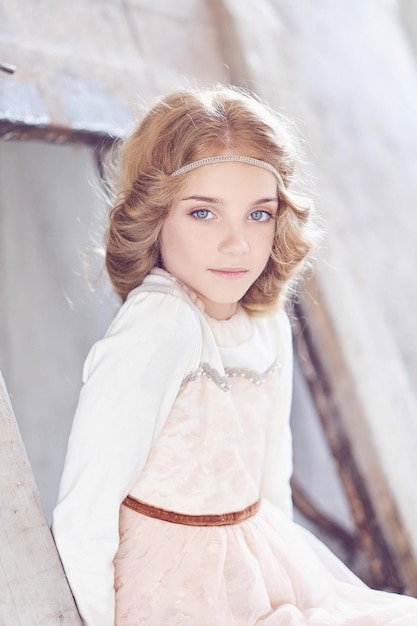 Portrait of a charming little girl model posing in a studio.