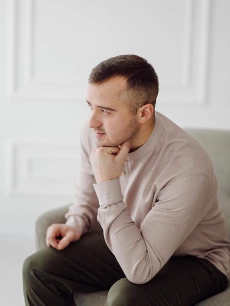 Portrait of a charming successful young businessman in a brown shirt