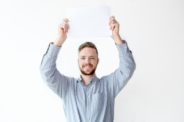 Free photo portrait of cheerful businessman holding placard