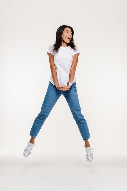 Portrait of a cheerful happy woman jumping