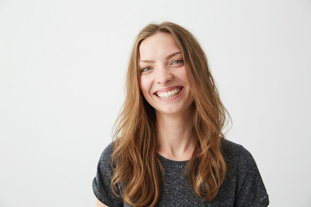 Portrait of cheerful happy young pretty girl smiling laughing .