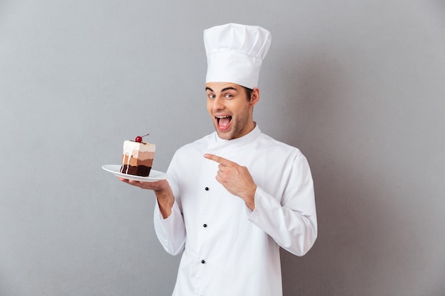 Portrait of a cheerful male chef dressed in uniform