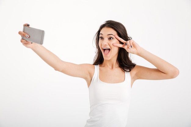 Portrait of a cheerful woman dressed in tank-top