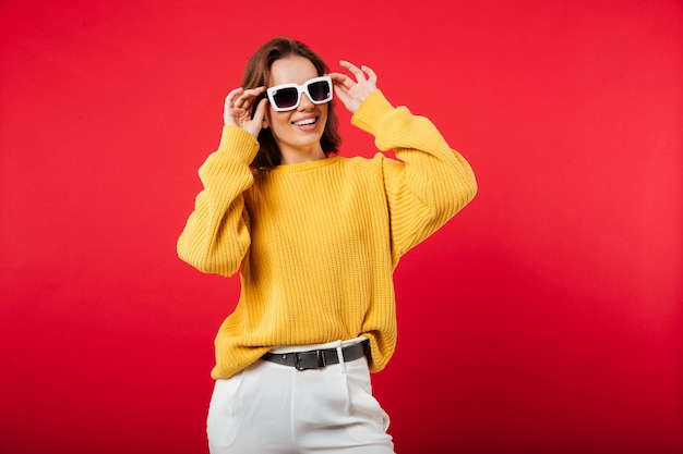 Portrait of a cheerful woman in sunglassed posing