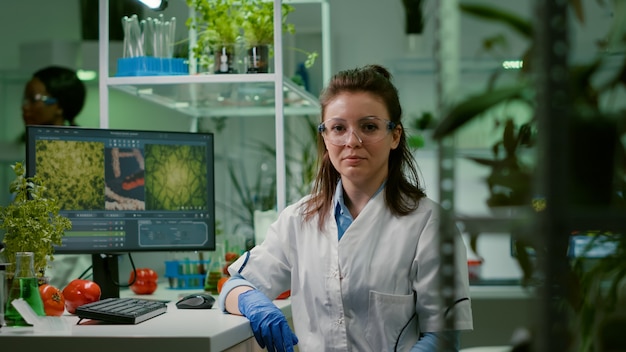 portrait of chemist woman in white coat working in pharmaceutical laboratory