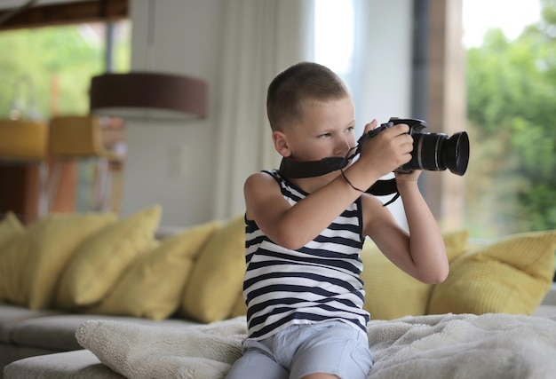 Free Photo portrait of a child at home with digital camera