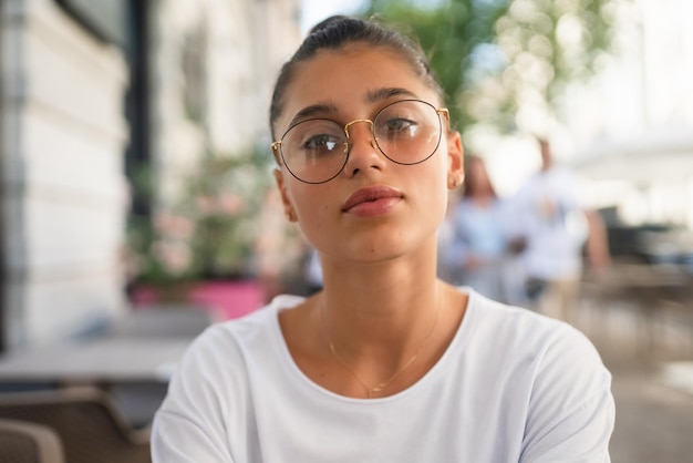 Portrait close up of young beautiful girl on street