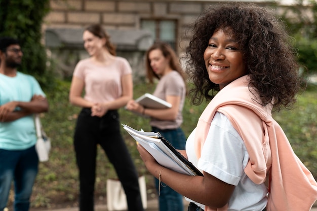 Portrait of college girl in front of her mates