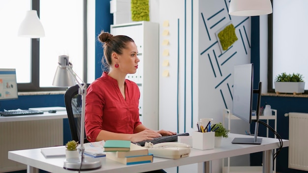 Portrait of company employee working on research statistics, planning financial sales development. Office worker using computer to create charts and graphs for business growth.