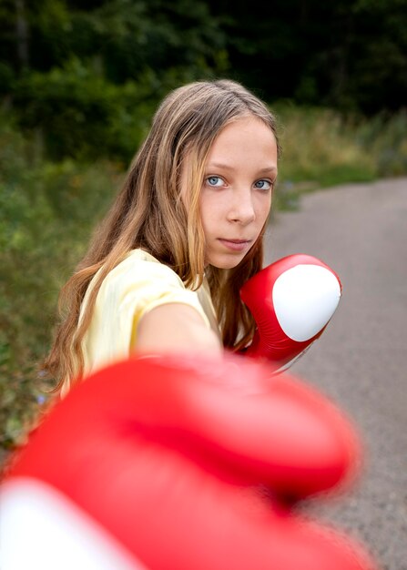 Portrait of confident girl with boxing gloves