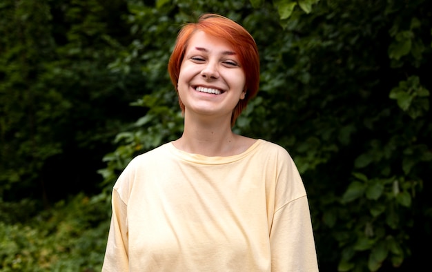 Portrait of confident redhead girl outdoors