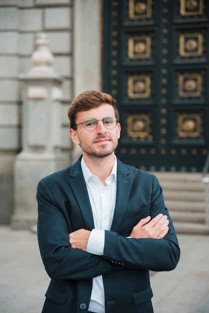 Portrait of confident young businessman with his arms crossed