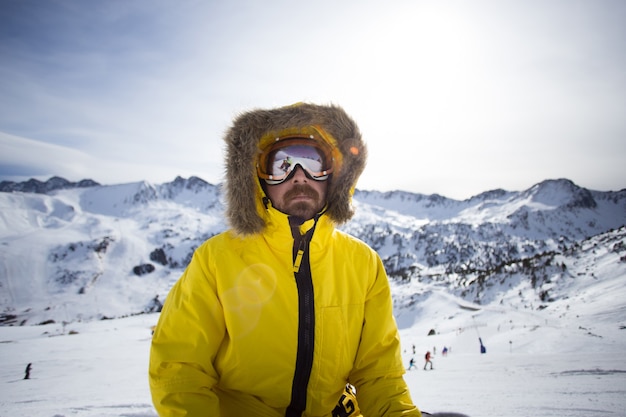 Free photo portrait of cool and rough snowboarder or skier, or mountaineer in warm winter yellow jacket