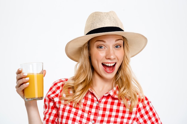 Portrait of country woman with juice on white.