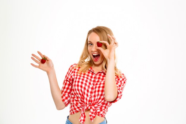 Portrait of country woman with strawberry on white.