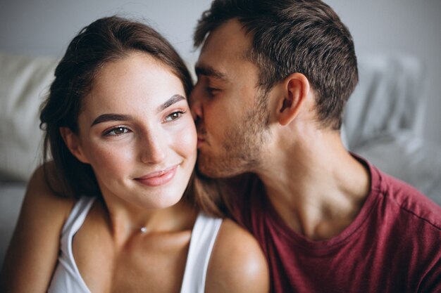 Portrait of couple at home together sitting on floor by the couch