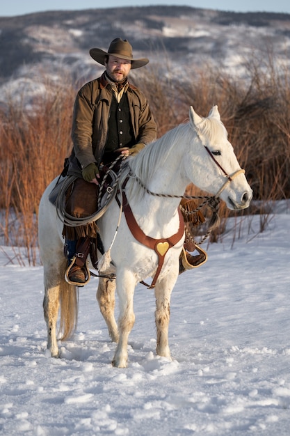 Free photo portrait of cowboy on a horse