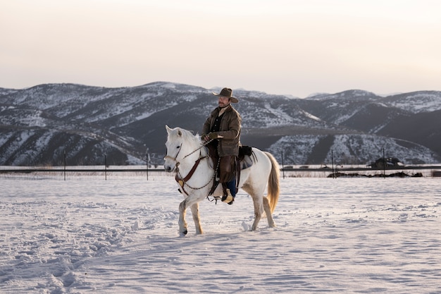 Free photo portrait of cowboy on a horse