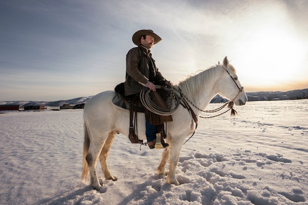 Free photo portrait of cowboy on a horse