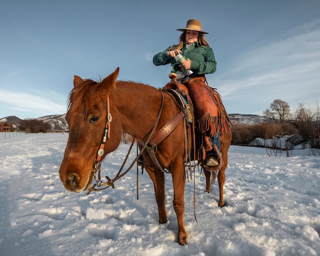 Free photo portrait of cowgirl on a horse