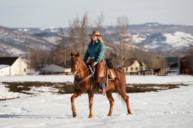 Free photo portrait of cowgirl on a horse