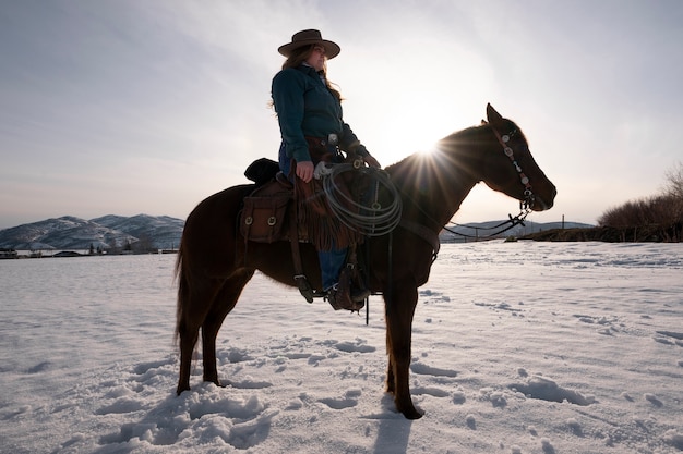 Free photo portrait of cowgirl on a horse