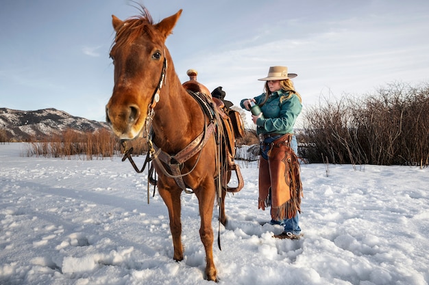 Portrait of cowgirl with a horse