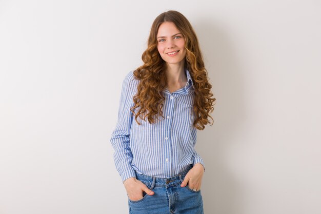 Portrait of curly pretty young woman with blond curly long hair