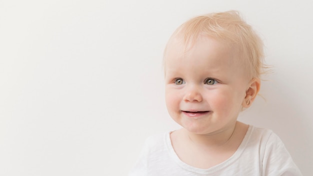 Free photo portrait of cute baby girl looking away