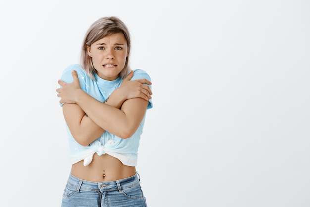 Portrait of cute blonde girl posing in the studio