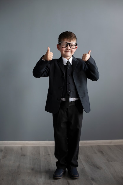 Portrait of cute child with suit and briefcase