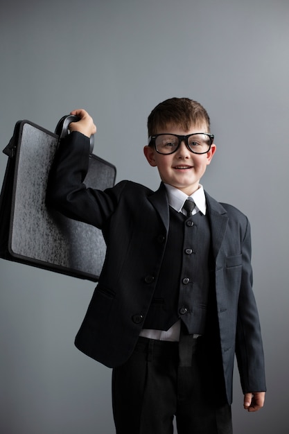 Portrait of cute child with suit and briefcase